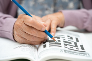 krupni kadar ruku starije ženske osobe koja rješava križaljku