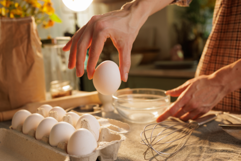 krupni kadar ženskih ruku koja u kouhinji priprema jaja