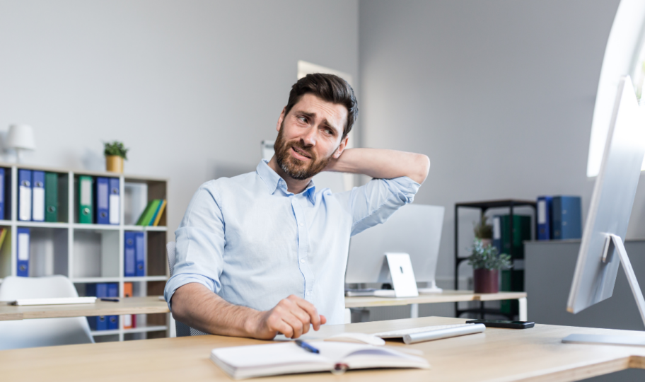 dekoncentrirani, zbunjeni muškarac sjedi za radnim stolom